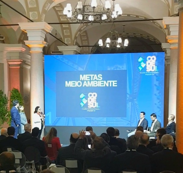 Secretária Marjorie no palco apresentando as pautas ambientais para os três governadores.